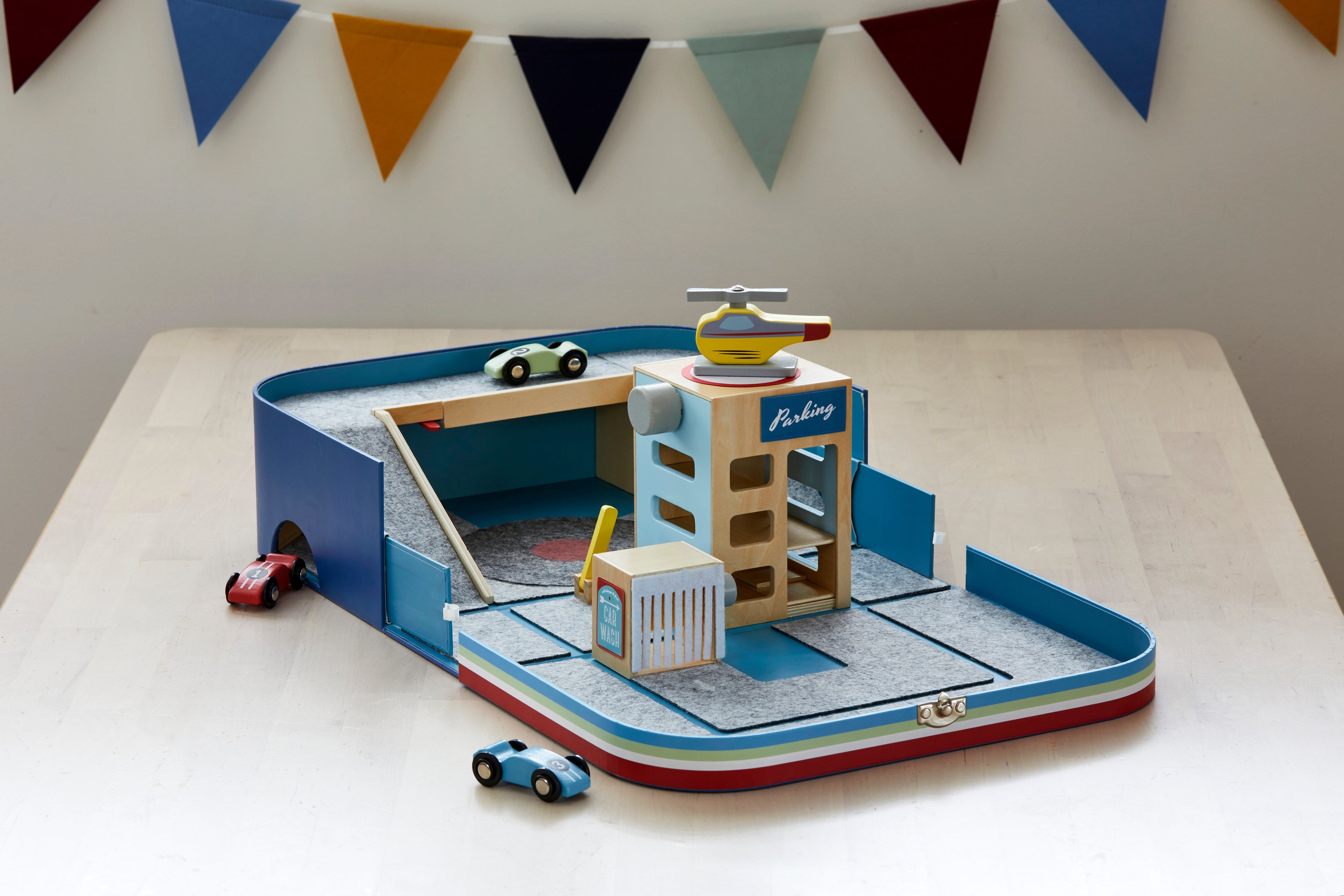 Load video: Children&#39;s educational car lover toy suitcase including two cars, helicopter, parking garage, car wash, bridges and tunnels. Supports children development. Sustainable and recycled materials (Fsc timber, recycled felt). Original, educational and ethically produced. Supporting cognitive, fine motor, problem solving skills &amp; imaginative play. Easy to pack and carry around. Suitable for 3+ years. Designed and prototyped in Australia. Environmentally friendly packaging.