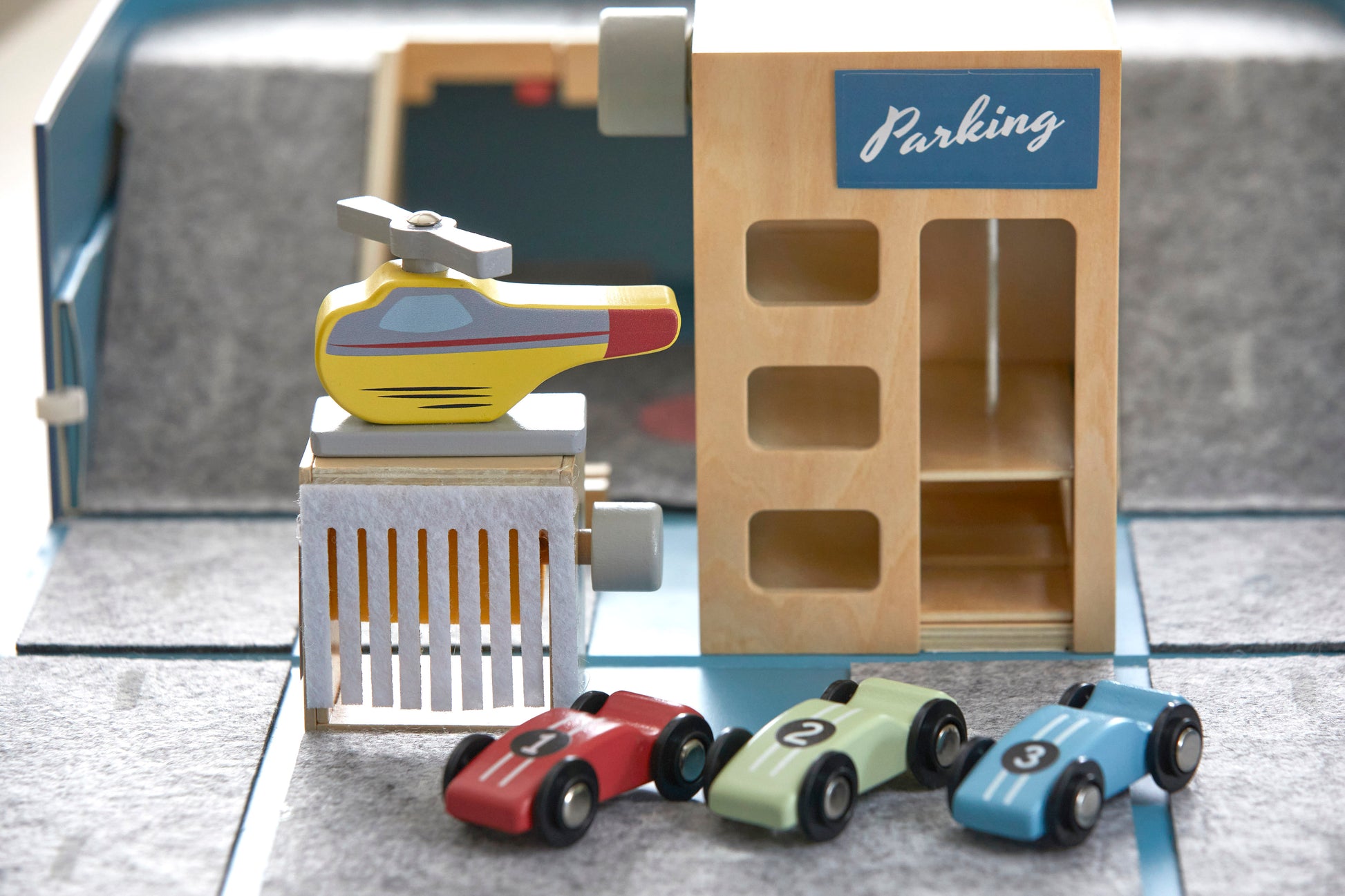 Car Suitcase. Includes parking garage, car wash, 3 cars, one helicopter, stickers and name tag for customising. Size 345 x 240 x 100 mm, car size: 6.5 x 2 x 3 cm (compatible with Matchbox cars). Materials: sustainable & recycled materials (FSC timber, recycled felt, cardboard). Original, educational , ethically produced. Supporting cognitive, fine motor, problem solving skills & imaginative play. Easy to pack and carry around. Suitable for children age 3+ years.  Designed and prototyped in Australia. 
