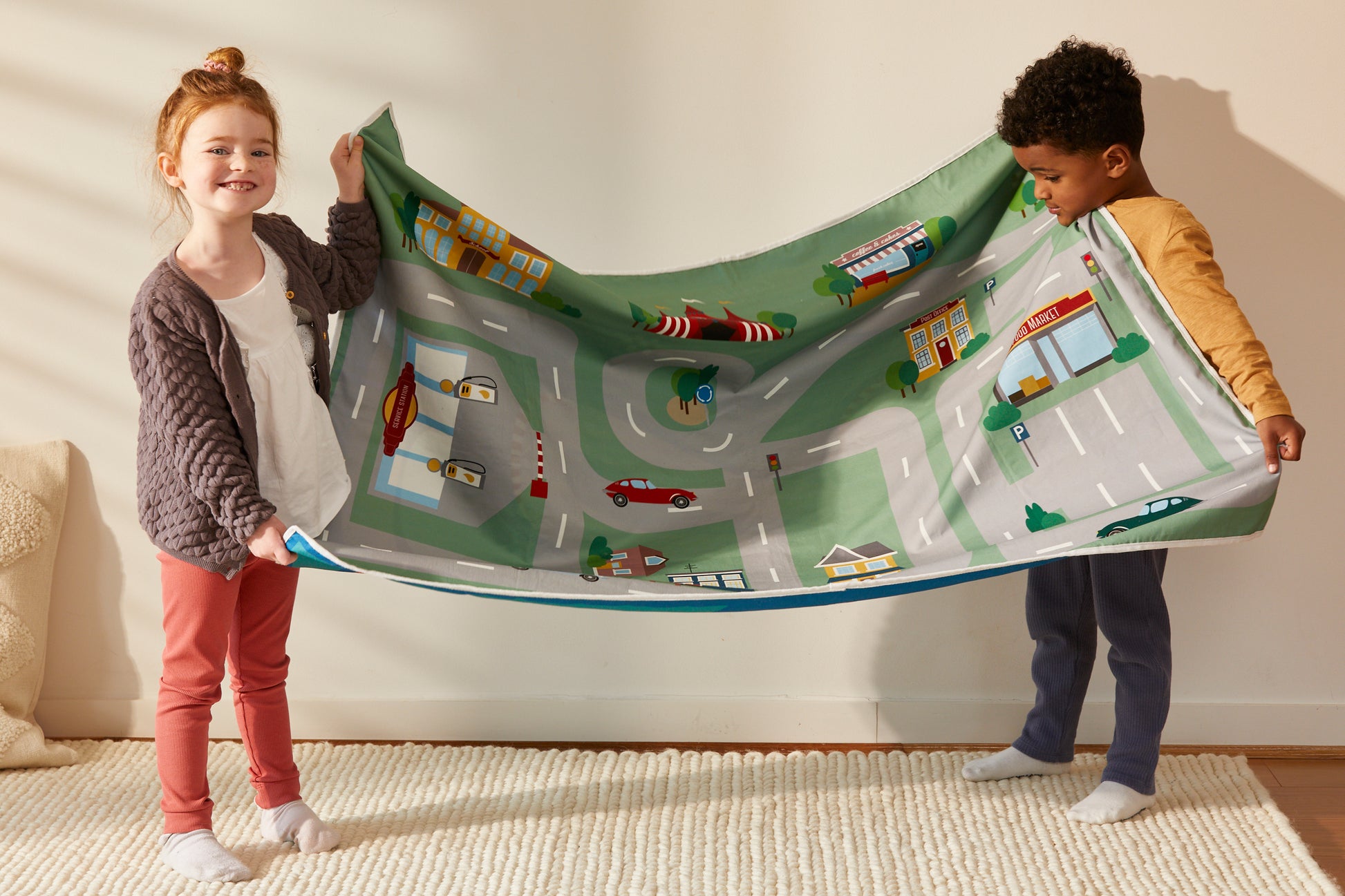 Children playmat, set 100% cotton and FSC timber cars. Size 1m x 1.4m includes carry strap and 2 cars. Double sided printed (Race track & town theme) Portable, lightweight, durable and washable. Perfect portable solution for busy caregivers. Supports your child's imagination. Environmentally friendly packaging.
